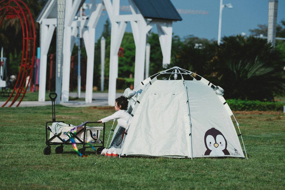 camping survival skills for kids practicing fire safety around a supervised campfire