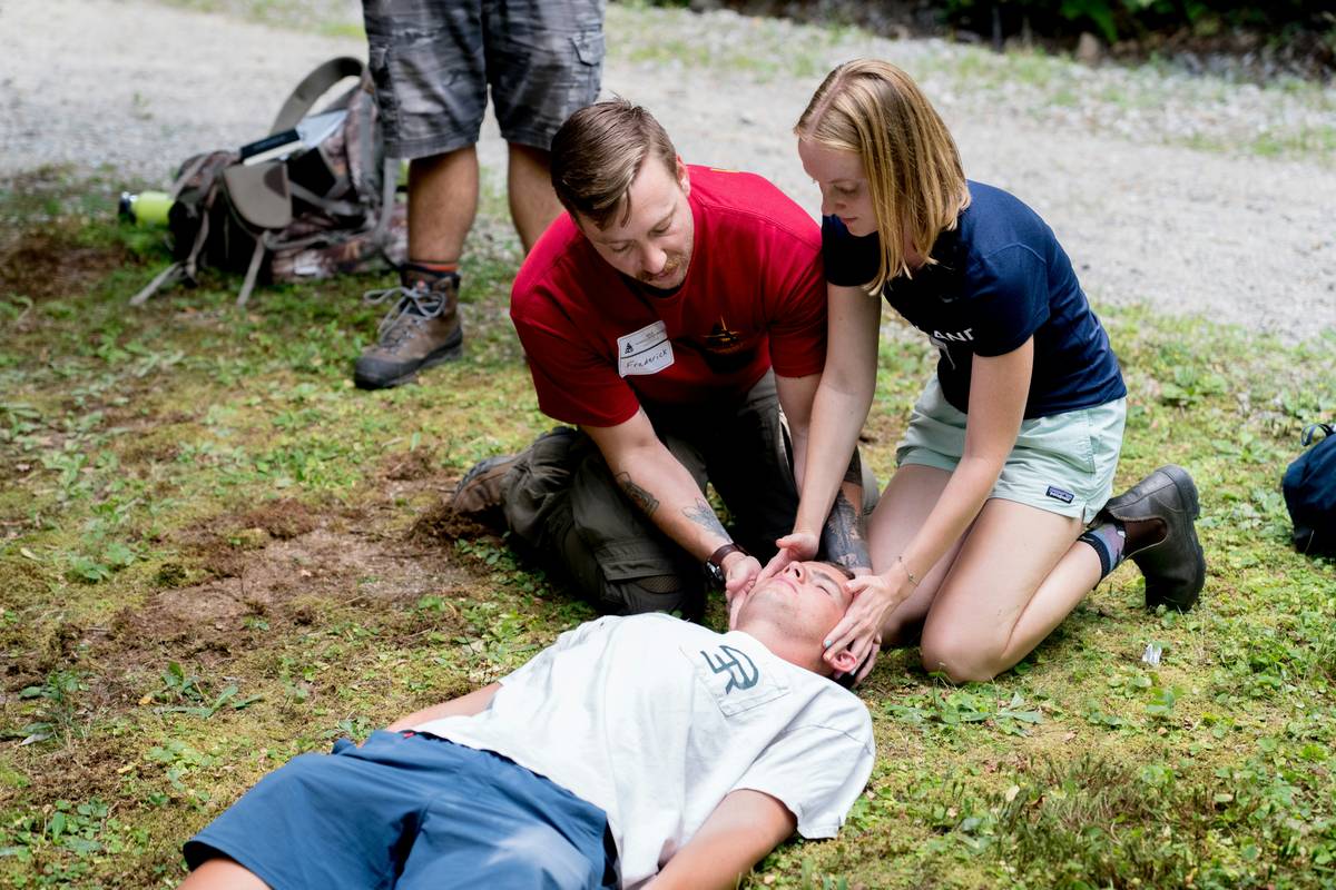 Camping survival skills quiz showing a hiker testing knot-tying and fire-starting techniques in a forest setting